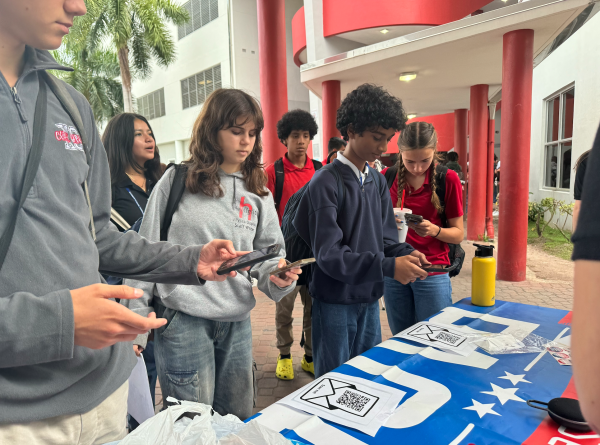 Surrounding the PACE Club's Mock Election stand, students scanned and voted for their preferred candidate, practicing civic engagement. 